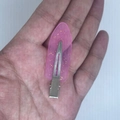 Pink transparent glitter hair clip held in hand for size visualization on white background - Transparent Purple with Gold Glitter