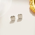 Elegant silver four-leaf clover stud earrings with intricate star pattern engraving - Silver Stud Earrings