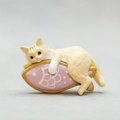 Cute cream cat resting on a pink fish resin ornament for desk edge and car console decor - Cat with Fish