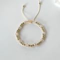 Detail view of gold beads and pink crystal cube beads on a flexible adjustable bracelet - Light Pink
