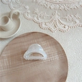 Close-up of iridescent acetate hair claw clip on wooden tray and lace background - Small Hollow Triangle / AB White