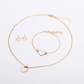 Detail shot of golden jewelry set featuring white heart pendants and lobster clasps - White