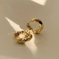 Close-up of gold hoop earrings with irregular hammered texture on a beige background - 1# Gold Wrinkle