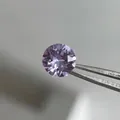 Sparkling purple round-cut zircon titanium steel stud earring shown with tweezers - 8mm Smoke Purple (Single Piece)