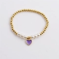 Elastic beaded bracelet featuring gold metal beads, white pearls, and a purple heart pendant - Purple