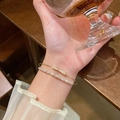Elegant gold-plated double-layer bracelet with sparkling zircon stones worn on wrist - S677 White