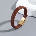 Brown braided leather bracelet with golden magnetic clasp on a stone background - Tan