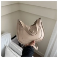 Detail of beige faux leather shoulder bag with heart accent and wide strap close-up - Khaki