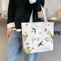 White canvas tote bag featuring floral and butterfly illustrations for spring fashion - Spring Awakening / White