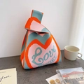 Knitted wrist bag with love heart pattern in orange and blue color block design - Orange Heart