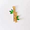 Macro shot of 18k gold bamboo pendant with green emerald stone and crystal accents - Green Bamboo*Gold