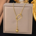 Elegant gold titanium necklace featuring a snake chain with a unique irregular ring and metal ball - Slide Bead Chain / Gold