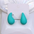 Matte turquoise teardrop earrings on a minimalist white display card and pedestal - Lake Blue