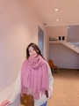 Pink wool-like cashmere scarf with tassels shown on a model for soft texture and drape - Plum Heather