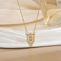 Close-up of gold titanium necklace with a rectangular gemstone pendant and micro-pavé diamonds - Gold Geometric Shield Zirconia Style (XL0475)