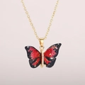 Macro detail of butterfly pendant with red and black marble texture and gold leaf accents - Gold Chain-Fantasy Red