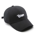 Close-up of white Vintage script embroidery on a black six-panel cotton baseball cap - Black