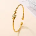 Golden open bangle with spiral texture and zircon-studded barrel bead detail - Size 5.6cm-Style 2