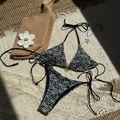 Two-piece black halter bikini with white daisy embroidery on woven beach mat - S / Black Daisy Embroidery