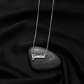 Macro shot of silver Gemini constellation necklace pendant on gray river stone - Gemini Steel