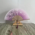 Japanese folding fan with pink gradient cherry blossom pattern and wooden frame - Peach and Plum Blossoms
