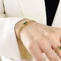 Golden double chain bracelet with green emerald gemstone and matching ring on model - Gold Green Zircon Bracelet