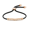 Macro view of rose gold bar engraved with 'She Believed She Could So She Did' quote - Rose Gold