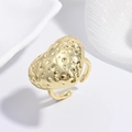 Close-up of golden heart ring with irregular hammered texture and open adjustable band - Gold Hammered Heart