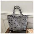 Gray corduroy tote bag with black diamond quilting and bow pattern in elegant setup - Gray