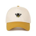 Detailed view of bee embroidery on a two-tone baseball cap with cotton twill texture - Yellow