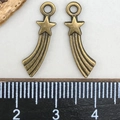 Bronze shooting star charms for jewelry making shown with a ruler for size scale - Antique Bronze Shooting Star Pendant (5x19mm)
