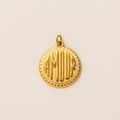 Macro detail of a 18k gold plated round pendant with embossed AMOUR lettering text - Coin Pendant