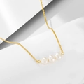 Detail view of a 925 silver necklace featuring three natural pearls on a gold-plated chain - 925 Silver / Gold