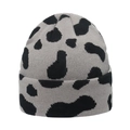 Detailed knit texture of a warm winter beanie with cow print pattern in grey and black - Grey and Black Cow Print