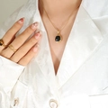 Elegant gold snake chain necklace with black square stone pendant on a white suit model - Gold Black Faux Pearl Necklace