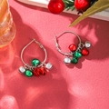 Detail of Christmas hoop earrings with vibrant red, green and silver bells on red background - D1308 (Colorful Bells)
