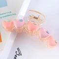 Detail of pink and orange heart hair claw clip on a white tray for a stylish look - Peach Pink + Pink Hearts