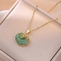Traditional Chinese Ruyi lock necklace in gold and green jade finish on a jewelry box - Auspicious Cloud Ruyi Necklace (X0058) / Gold