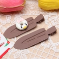 Detail of brown duckbill hair clips with a cute 3D donut charm on white lace background - Coffee