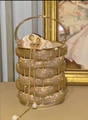 Golden woven bucket bag featuring sparkling crystals and a decorative pearl chain - Gold