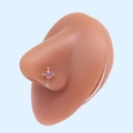 Detail of cross-shaped L-shaped nose stud with oval pink zircon on a silicone nose model - Silver Cross Pink Gemstone (#6)