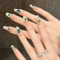 Detail of luxury emerald cat-eye press-on nails with gold accents and green jewels - XS / Medium Coffin Style (2854)