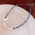 Detail of beaded necklace featuring blue beads, baroque pearls, and a white butterfly pendant - 5# Necklace - Blue Butterfly Pearl