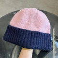 Detail of pink and navy blue color-block knitted beanie showing thick textured wool material - One Size / Pink and Navy Blue