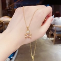 Detailed view of golden bear necklace with zircon micro-pave and pink heart gemstone - Gold Pink Heart Bear