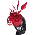 Elegant red fascinator hat with feathers and floral details on a black mannequin - Burgundy