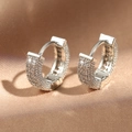 Sparkling silver hoop earrings with full pavé crystals on a silk fabric background - White/Silver