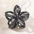 Detail of glossy black hollow frangipani hair claw clip with metallic finish - 7.5cm Hollow Frangipani / Gunmetal