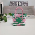 Detail shot of the pink and green woven texture and zigzag edges of this basket bag - Mini Pink Patchwork