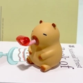 Cute yellow Capybara squeeze toy with red party blower detail for stress relief - Tongue Out Style